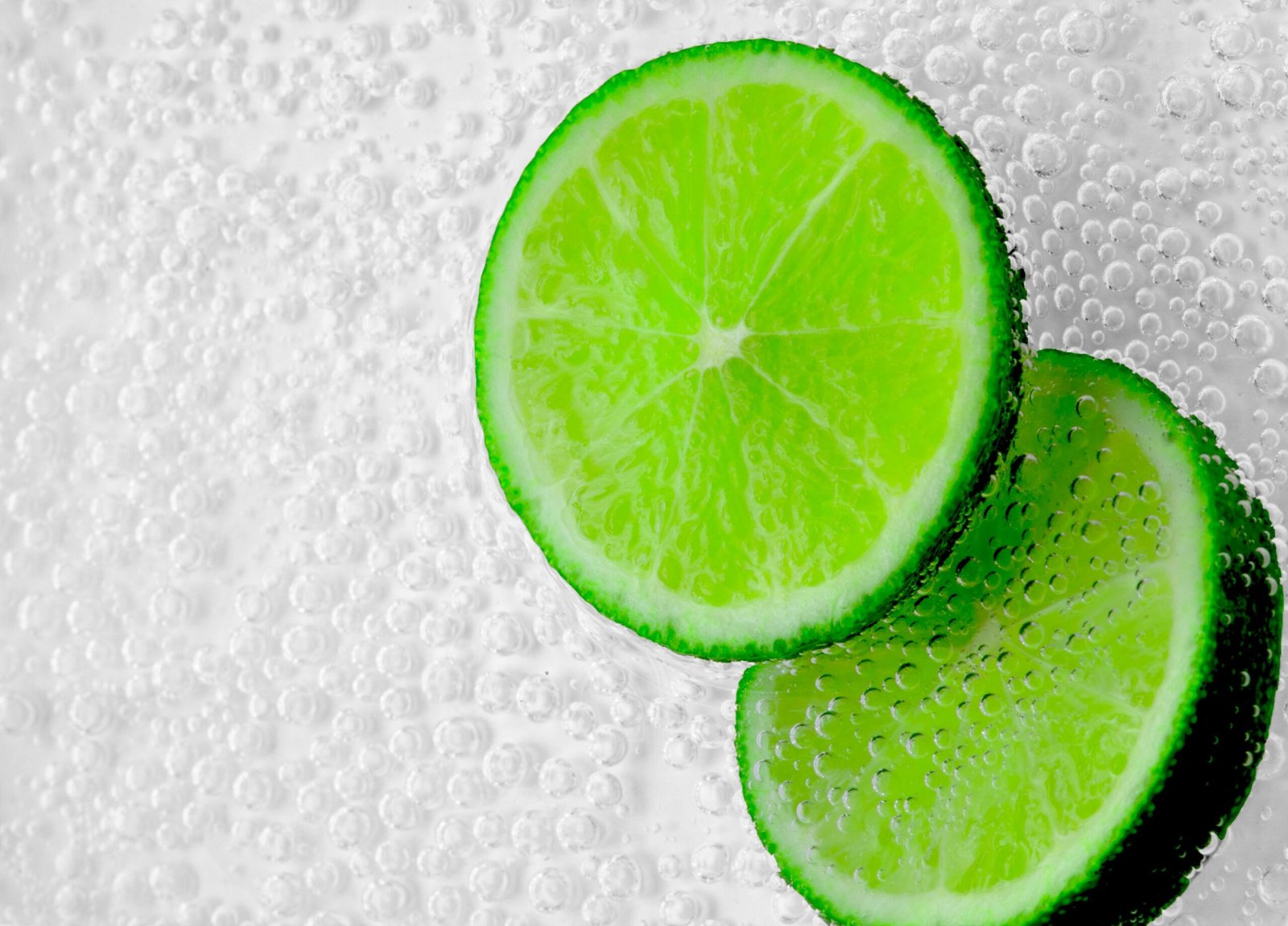 Close-up of lime slices in sparkling water showcasing freshness and citrus zest.